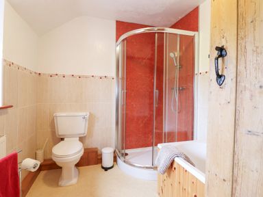 A bathroom with a shower, toilet, and bathtub at Bryn Re Trawsfynydd near Llan Ffestiniog and Dolgellau