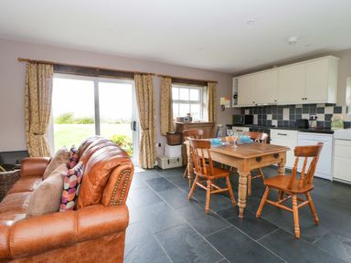 A kitchen with a table and chairs at Blaenffynnon Bach in Trelech near Crymych