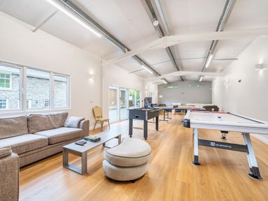 A games room with sofas a foosball table a ping pong table and an air hockey table at Old Rectory Cottages Aberhafesp near Newtown