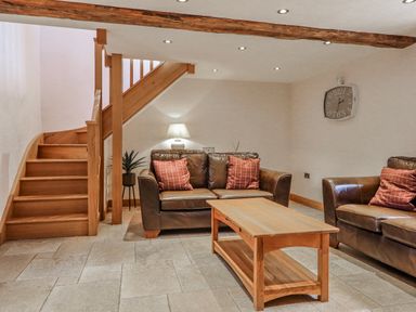 A living room with sofa, coffee table and staircase at Briws and 963354 together they sleep 35
