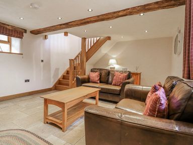 A living room with seating and a staircase at Briws and 963354 together they sleep 35