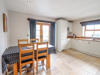A kitchen with a table and chairs at Briws and 963354 together they sleep 35