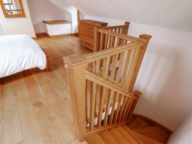 A bedroom with a bed and staircase at Briws and 963354 together they sleep 35