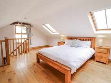 A bedroom with a bed and windows at Briws and 963354 together they sleep 35