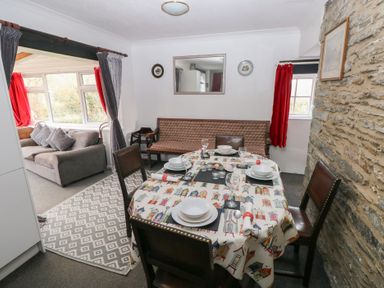 A dining room with a table set for dinner at Maesgwyn in Bridell near Cardigan