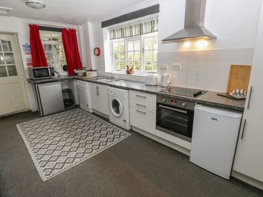A kitchen with appliances and a dining area at Maesgwyn, Bridell near Cardigan