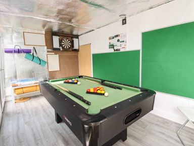 A game room with a pool table darts board and yoga mats at Beautiful Cotswold View in Bourton-On-The-Water