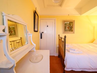 A bedroom with a mirror and bed at Murmur Y Don in Harlech