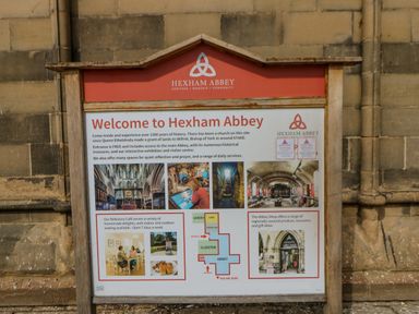 A welcome sign for Hexham Abbey with information and images of the abbey and its facilities at East Farm House in Humshaugh near Hexham