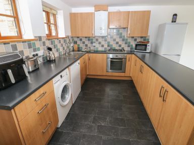 A kitchen with appliances and cabinets at Bwthyn-y-Rhiw Penybanc near Llandeilo