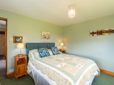 A bedroom with a double bed and two bedside tables with lamps at Browside in Little Arrow near Coniston