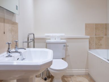 A bathroom with a sink toilet and bathtub at Newlands in Graythwaite near Hawkshead