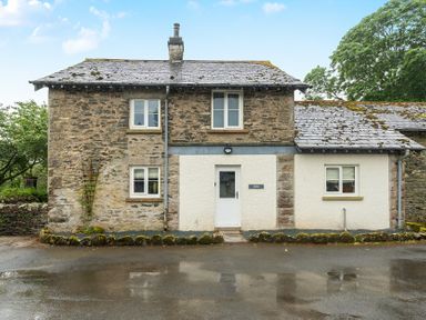 A cottage with stone walls and a front door at Jubilee at the Graythwaite Estate near Hawkshead