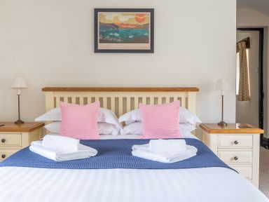 A bedroom with a bed and nightstands and lamps at Hilltop in Graythwaite near Hawkshead
