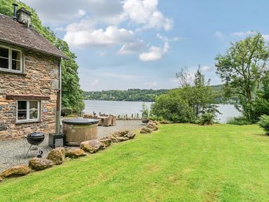 An outdoor space with a house by the lake at Hammerhole at the Graythwaite Estate near Hawkshead