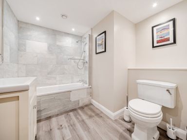 A bathroom with a bathtub, shower, sink, and toilet at Hammerhole at the Graythwaite Estate near Hawkshead