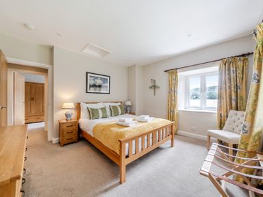 A bedroom with a bed and nightstand at Hammerhole at the Graythwaite Estate near Hawkshead