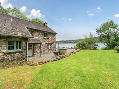 An outdoor area with a house and lake at Hammerhole at the Graythwaite Estate Graythwaite Estate near Hawkshead