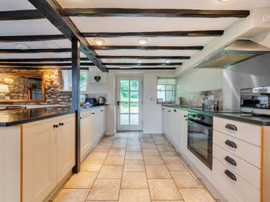 A kitchen with cabinets and appliances at Hullet Hall at the Graythwaite Estate near Hawkshead