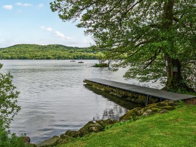 A view of a dock on water surrounded by trees at Hullet Hall at the Graythwaite Estate near Hawkshead