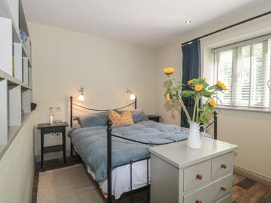 A bedroom with a bed and bedside table at The Stable Deepdean near Ross-on-Wye