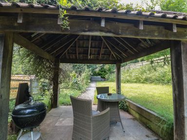 A gazebo with a table and chairs and a barbecue at The Stable Deepdean near Ross-on-Wye