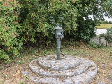 A water pump on a stone base in a garden at Mrs Delaney's Loft Ardfinnan near Clonmel County Tipperary