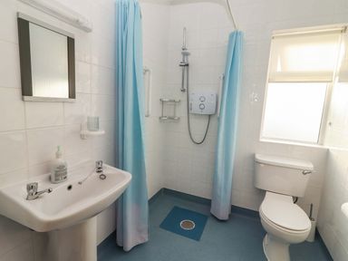 A bathroom with a sink, toilet, and shower at Moybella Lodge in Lisselton near Ballybunion, County Kerry