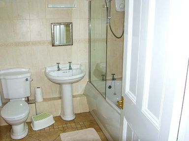 A bathroom with a toilet sink bathtub and shower at The Grange in Little Haven near Haverfordwest