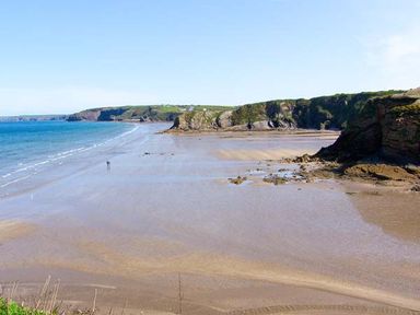 A beach view with sand and cliffs along the shoreline at The Grange in Little Haven near Haverfordwest