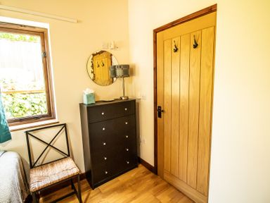 A bedroom with a window and furniture at Sycamore Lodge Nantmel near Rhayader