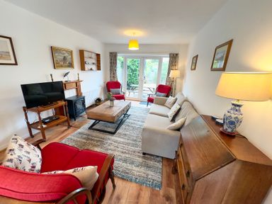 A living room with a television and a coffee table at 38 Dale End, Brancaster Staithe near Burnham Market