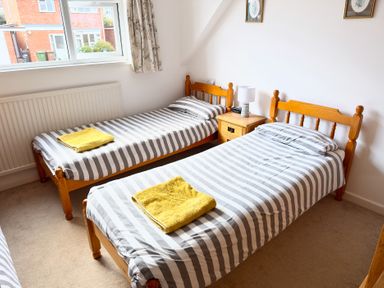 A bedroom with two single beds and a nightstand at 38 Dale End Brancaster Staithe near Burnham Market