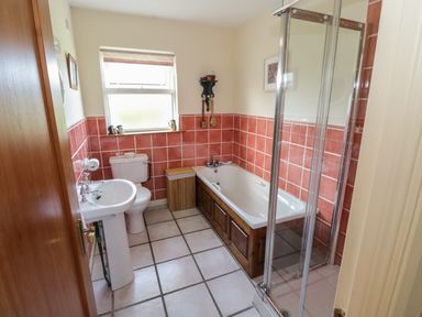 A bathroom with a sink toilet bathtub and shower at Teach Teolai in Carraroe County Galway