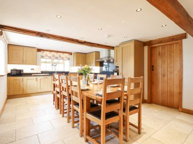 A dining room with a table and chairs at Ty Gwyn in Llangwm near Bala