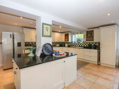 A kitchen with appliances and countertop space at Nant-yr-Rhedyn in Red Wharf Bay