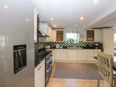 A kitchen with appliances and countertop features at Nant-yr-Rhedyn Red Wharf Bay
