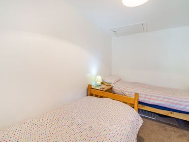 A bedroom with two single beds and a small bedside table with a lamp at No 7 Spark Bridge near Ulverston