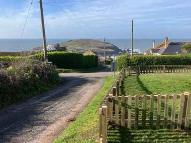A view of the ocean and houses along the road at Quarterdeck in Bigbury-on-Sea near Modbury