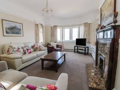 A living room with sofas coffee table tv and fireplace at Seascape in Bridlington