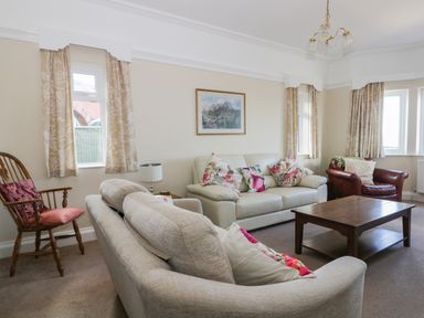 A living room with sofas wooden chair and coffee table at Seascape in Bridlington