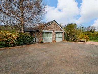 A house with a driveway and garden at The Lodge, Lower Trefedw in Pandy near Abergavenny