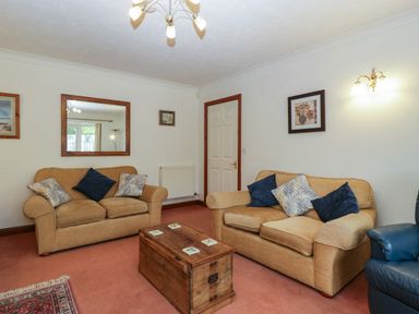 A living room with two beige sofas and a wooden chest coffee table at Hurst Green in Ewyas Harold near Hereford
