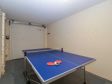 A game room with a ping pong table and paddles at Hurst Green in Ewyas Harold near Hereford