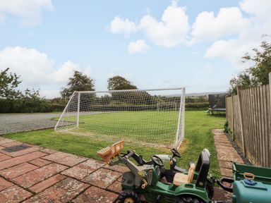 An outdoor space with a goalpost and toys at Hayloft Cottage in Bolton Low Houses