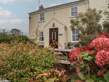 A house with a front door and garden at Garth Cottage in Haverfordwest