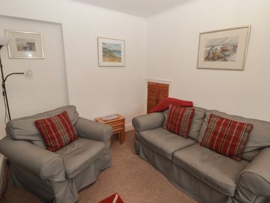 A sitting room with two sofas and a table at Garth Cottage in Haverfordwest
