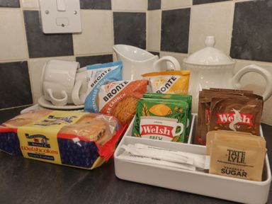 A kitchenette with tea and cookies at Garth Cottage in Haverfordwest