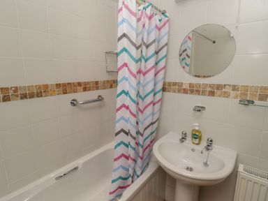 A bathroom with a bathtub and sink at Garth Cottage in Haverfordwest