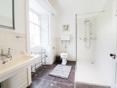 A bathroom with a sink toilet shower and window at Bryn Derwen Bethesda near Caernarfon
